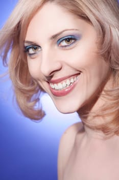 Beautiful young woman with blond hair and bright smile