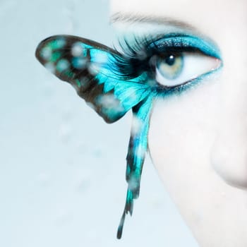 Eye of a young woman with butterfly wings