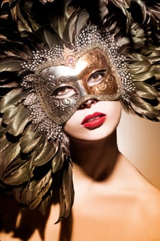 Young beautiful woman with Venetian mask