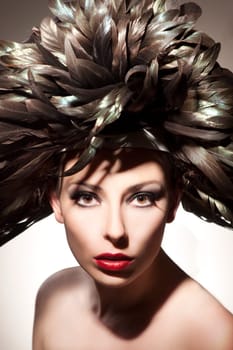 Young,beautiful woman with feathered hat