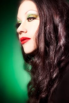 Beautiful young woman with red lipstick and long curly hair