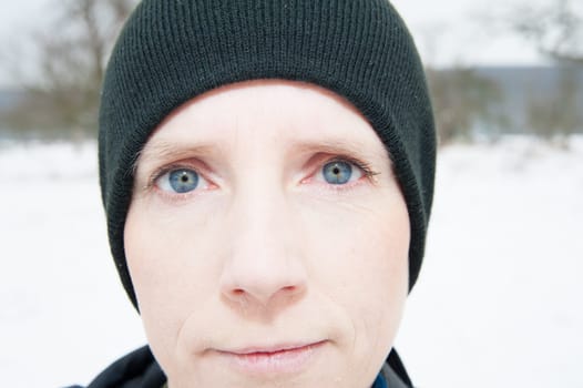 Woman with blue eyes in the snow