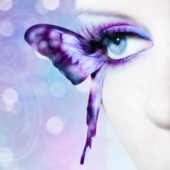 Eye of a young woman with butterfly wings