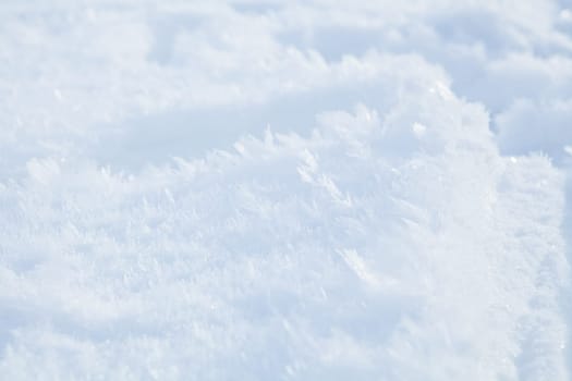 Closeup of delicate icy snow crystals outdoors in winter