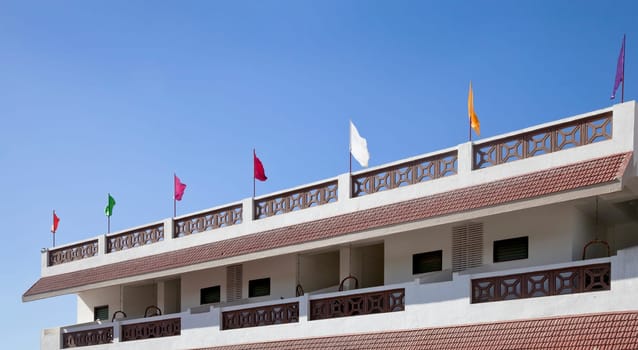 Panoramic landscape of multi colored flags waving in the gentle breeze coming off the Arabian Sea 5 kilometers outside Dwarka Gujarat India on the coastal road from Mangrol