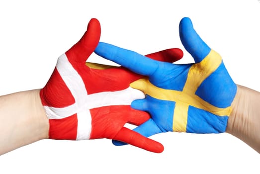 two painted hands handshaking in red, blue, white and yellow