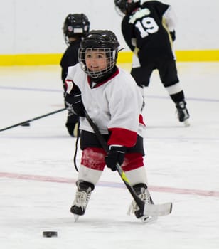 Little boy playing ice hockey