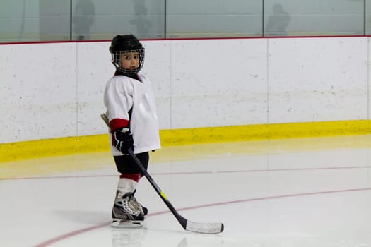 Little boy playing ice hockey