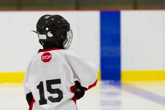 Little boy playing ice hockey