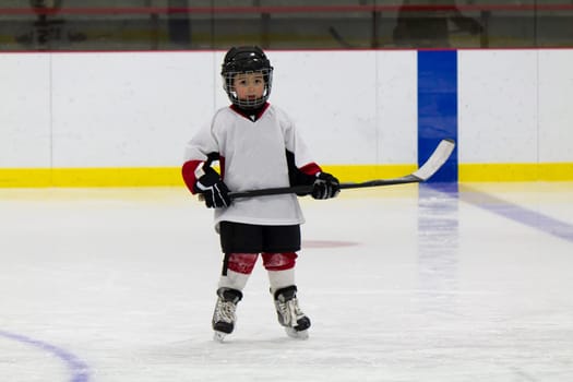 Little boy playing ice hockey