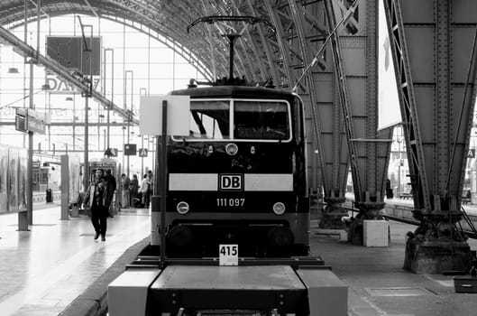 Frankfurt,Germany – November 08,2012: The interior shot of Frankfurt Central Station with unknown people. In the foreground is a train of the German Federal Railway.