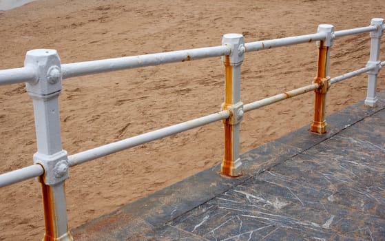 The rusty railing on the beach