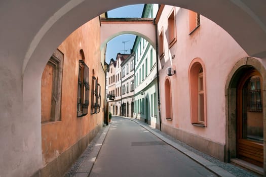 Pardubice, East Bohemia, Czech Republic. Old street near Pernstynske namesti (main square) under arches.