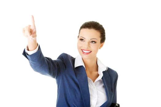 Young beautiful businesswoman making choose on abstract screen