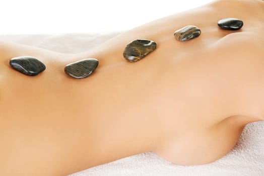 Beauty woman relaxing in spa. Hot stone massage.