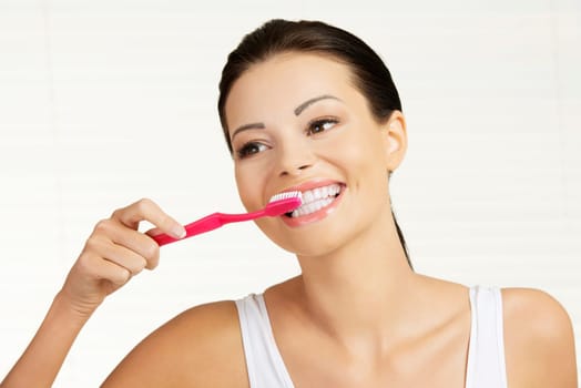 Woman with great teeth holding tooth brush