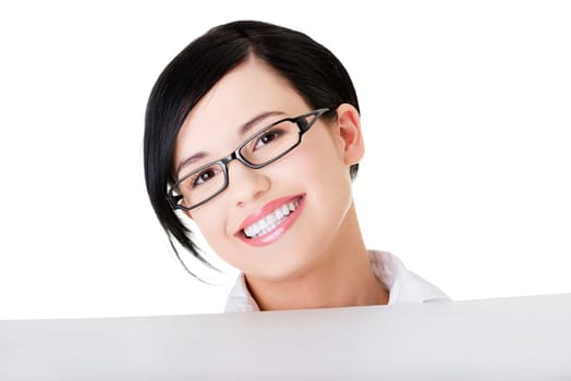 Smiling young business woman showing blank signboard, over white background isolated