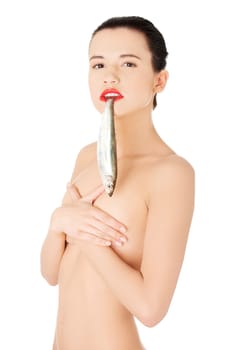 Beautiful young naked woman with fish in her mouth