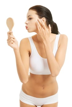 Attractive woman with handy mirror, isolated on white