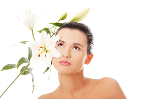Portrait of beautiful young woman with health skin and with lily flower