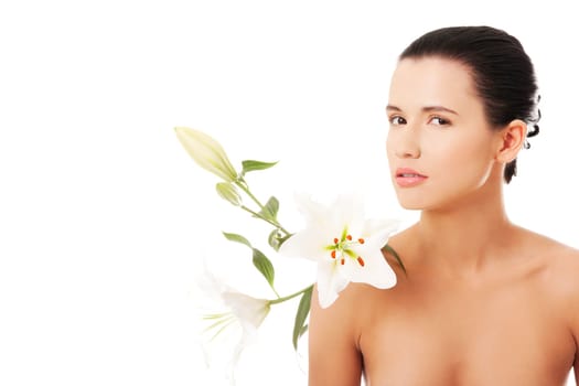 Portrait of beautiful young woman with health skin and with lily flower