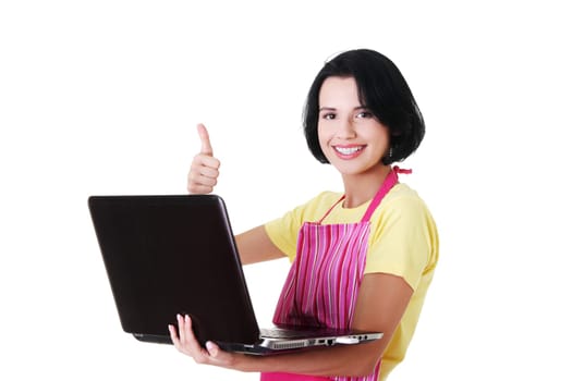 Young woman in pink apron using laptop, isolated on white