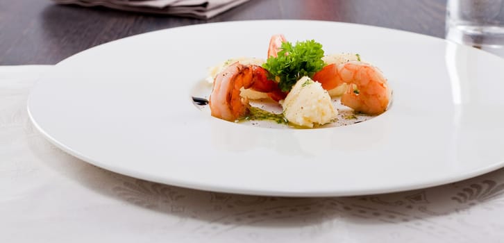 fresh fried prawns with mashed potatoes and green herb sauce on white plate