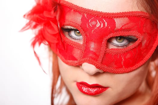 Young woman with red carnival mask