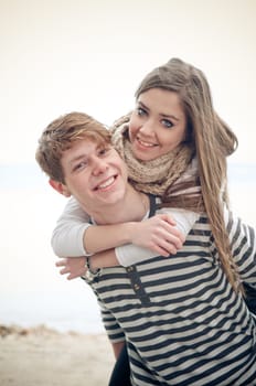 Teenage girl getting a piggyback from her boyfriend