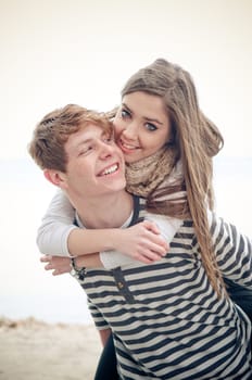 Teenage girl getting a piggyback from her boyfriend