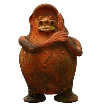 A fat little ceramic statue sitting on a stone wall isolated against white.