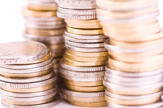 Piles of euro coins isolated on white, money closeup