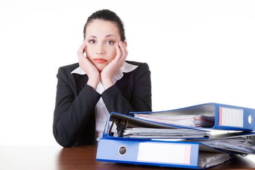 Sad woman with ringbinders sitting at the desk. Tired and exhousted business woman.
