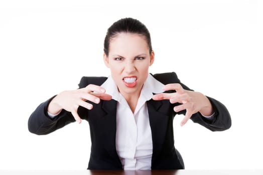 Angry businesswoman at the desk, isolated on white background