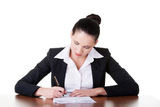Beautiful attractive corporate lawyer business woman sitting at desk and writing blank paper page, isolated on white background.