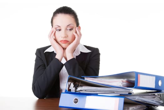Sad woman with ringbinders sitting at the desk. Tired and exhousted business woman.