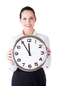 Happy young business woman holding office clock, isolated on white background