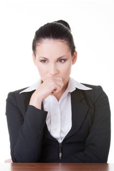 Sad business woman sitting behind the desk, isolated on white