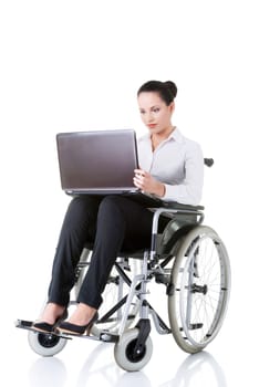Attractive smiling disabled businesswoman sitting in a wheel chair isolated on white