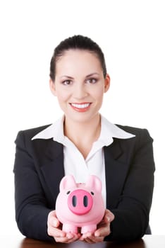 Happy business woman with her savings at the desk, isolated