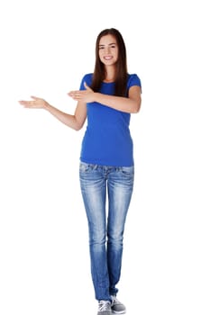 Happy , excited young woman pointing on copy space, isolated on white