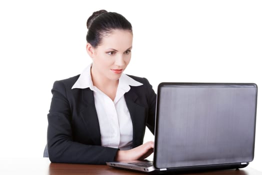 Beautiful brunette businesswoman working on laptop computer isolated on white