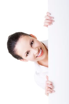 Smiling young business woman showing blank signboard, over white background isolated