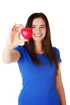 Pretty teen girl showing red heart in her hand over white.