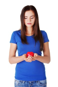 Teen girl holding red heart. Isolated.