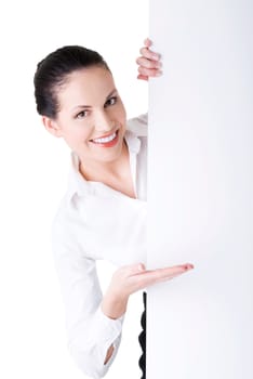 Smiling young business woman showing blank signboard, over white background isolated