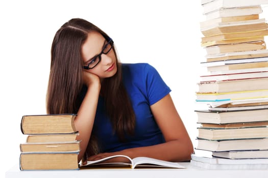 Teen girl learning at the desk, isolated on white