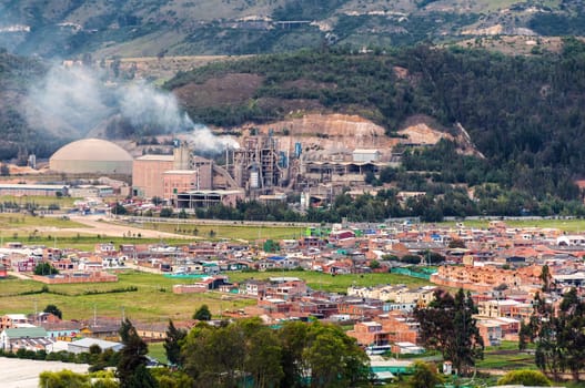A polluting factory with a small town around it