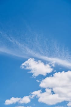 White cumulus clouds on a bright blue sunny sky. High quality photo
