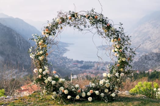 Round wedding arch stands on a mountain on the Bay of Kotor in the valley. High quality photo